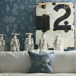 Wychwood Happy Blue Wallpaper -Andrew Martin Store 214538 wychwood happy blue wallpaper with laurent sofa and scatter cushion in friendly folk happy blue fabric