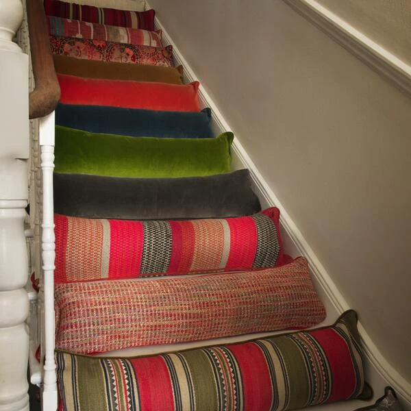 Medici Raw Umber Draught Excluder Cushion Medici Raw Umber Draught Excluder Cushion -Andrew Martin Store 353167 draught excluder stair group shot sml